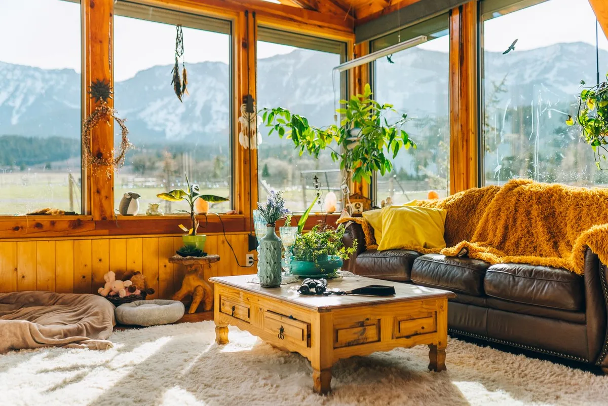 A warm living room with large windows